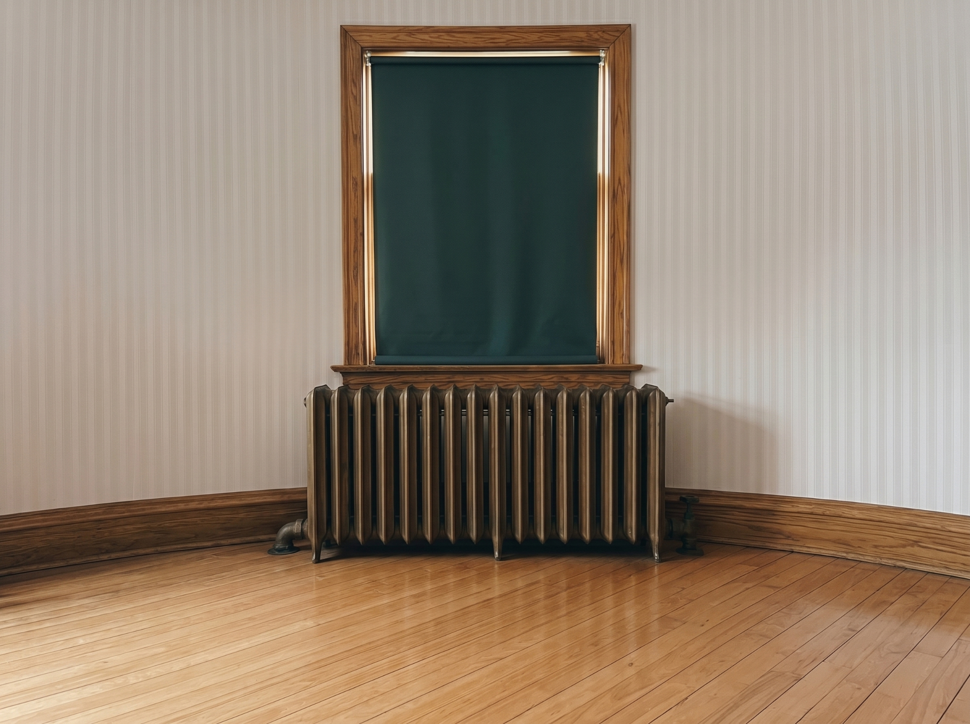 Classic cast-iron radiator beneath a window in a restored interior